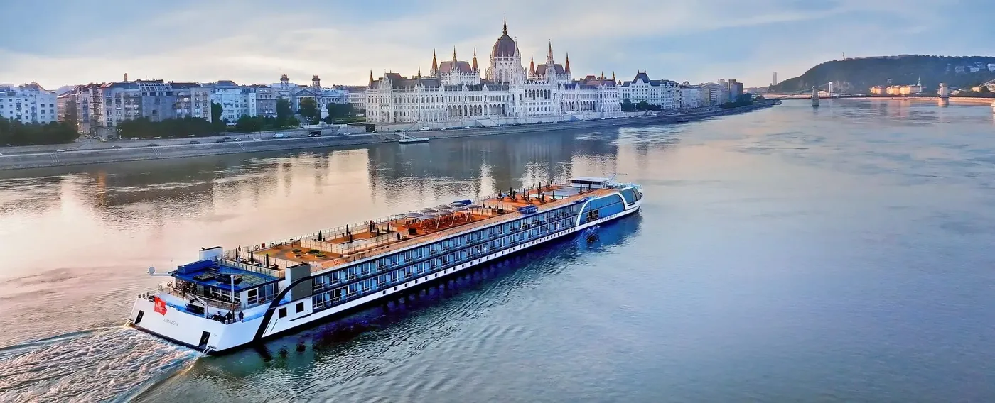 AmaWaterways river cruise ship on the Danube River passing the Hungarian Parliament Building in Budapest